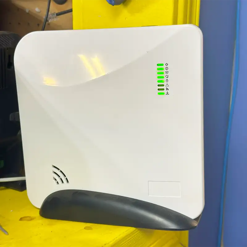 A white alarm panel box on top of a yellow table