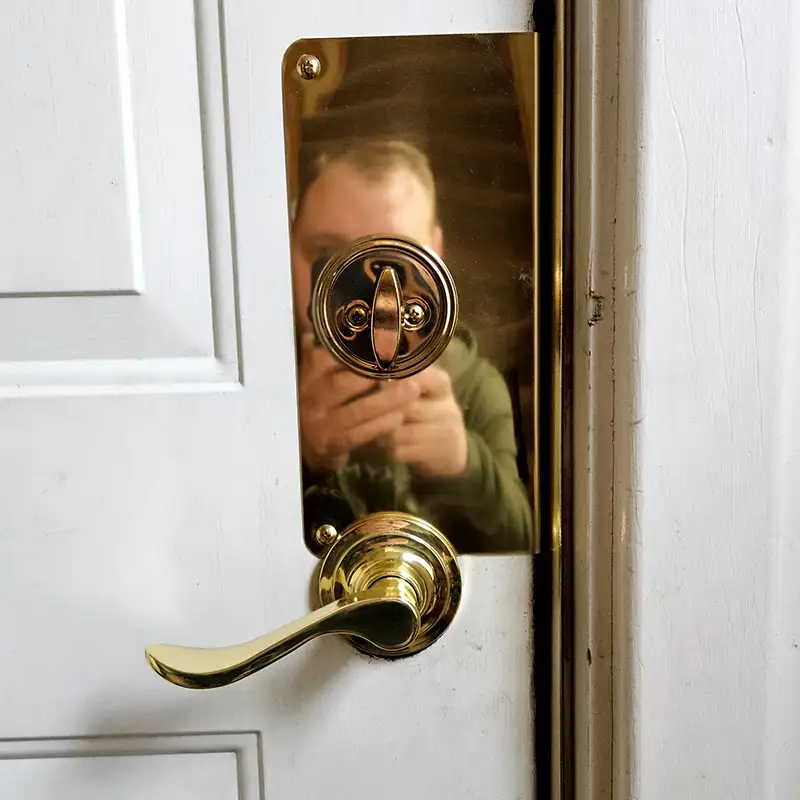 A new brass door handle with a lock and door wrap