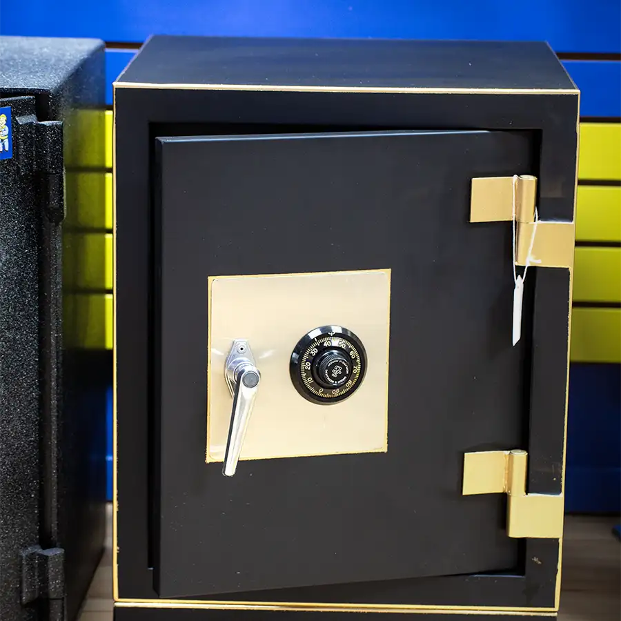 A safe with a golden plate and black dial