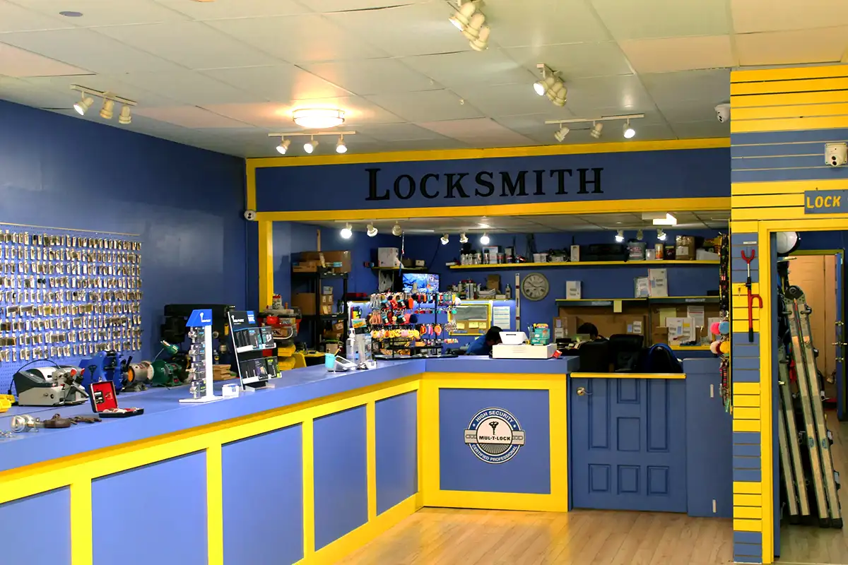 A locksmith shop in with the word LOCKSMITH written on a sign inside the store.